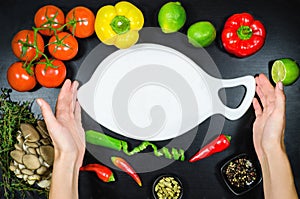 Phone and white cutting board among the vegetables. Top view