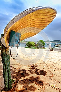 Phonebooth with a shell-shaped cover in Buzios, Brazil photo