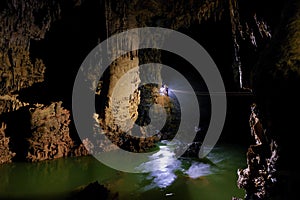 Phong Nha Ke national park / Vietnam, 16/11/2017: Group ziplining over an underground river inside the giant Hang Tien cave in the photo