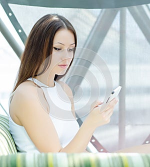 Phoning woman sitting relaxed at cafe