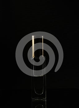 Phoography in a low key. perfume bottle on a dark background photo