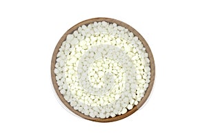 Phosphate fertilizer granules in a wooden bowl