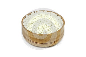 Phosphate fertilizer granules in a wooden dish