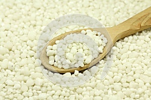 Phosphate fertilizers in a wooden spoon