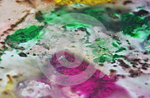 Phosporescent green pink red yellow bright colors and hues. Abstract wet paint background. Painting spots.