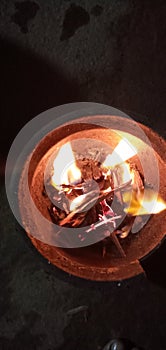 Phot of fire on the clay pot in winter sessions  at our door photograph