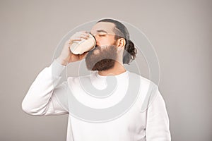 Phot of tired office worker man drinking cup of coffee for more cafeine