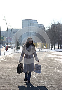 Photo 15. Happy young girl with black long hair. Shopping. 2022