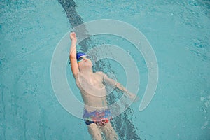 Photo of a 7-year boy playing and swimming in the swimming pool