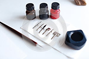 Photo of accessories for calligraphy and lettering on white tabl