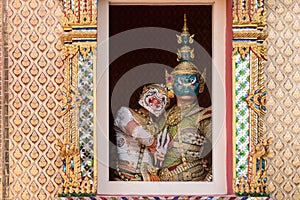 photo of actors in Khon drama, portraying Ravana and Hanuman from the Ramayana, elegantly posing in traditional attire and masks
