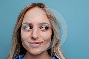 photo of adorable casual young woman with smiling eyes on blue background