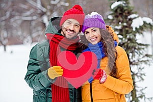 Photo of adorable charming girlfriend boyfriend dressed vests smiling hugging holding red heart walking snow outdoors