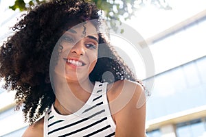 Photo of adorable cute good mood girl enoying sunny morning in big town cityscape background