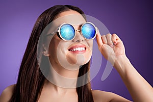 Photo of adorable funny mature woman naked shoulders smiling wear sunglass  violet color background