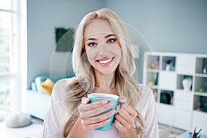 Photo of adorable gorgeous girl freelancer have free time hot cacao pastime weekend breakfast modern room interior