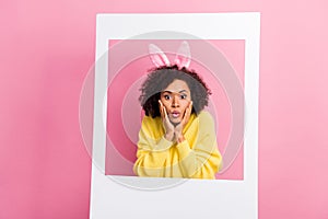 Photo of adorable impressed woman dressed kitted pullover easter headband arms cheeks photo frame isolated pink color