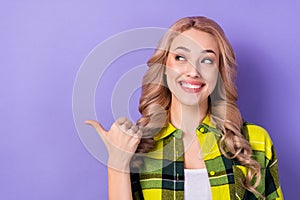 Photo of adorable lady direct thumb finger empty space wonder news ad ads adv wear plaid shirt isolated violet color