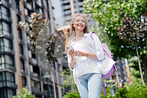 Photo of adorable positive carefree girl going shopping pastime promenade weekend time modern city photo