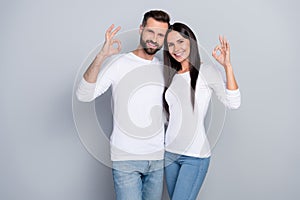 Photo of adorable pretty young brother sister dressed white shirts showing two okey signs isolated grey color background