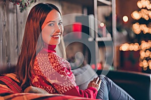 Photo of adorable pretty young woman dressed red sweater having rest enjoying new year smiling indoors room home house