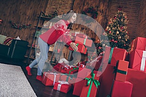 Photo of adorable pretty young woman dressed red sweater putting gifts under new year tree smiling indoors room home