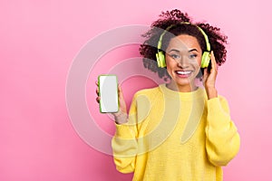Photo of adorable sweet woman dressed kitted pullover listening songs modern device empty space isolated pink color