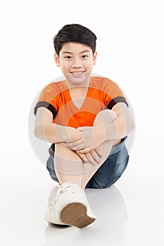 Photo of adorable young happy asian boy looking at camera