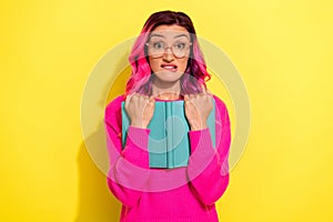 Photo of afraid scared girl dressed vibrant pullover eyewear reading scary book isolated yellow color background