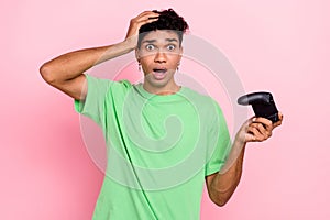 Photo of afraid stressed depressed guy player have fun free time play video game lost competition isolated on pink color