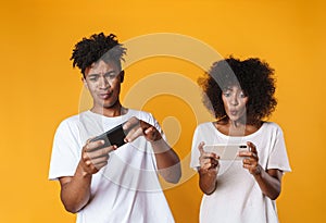 Photo of african american people playing online game on cellphone