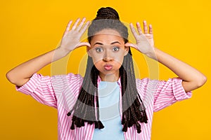 Photo of african funky lady palms head inflate cheeks mock wear striped shirt isolated yellow color background