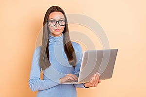 Photo of agent brunette young lady write laptop wear eyewear blue pullover isolated on beige color background