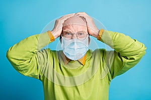 Photo of aggressive old man hands head mad look wear blue face mask isolated blue color background