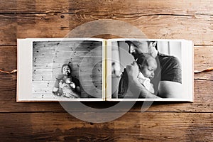 Photo album with pictures of father and baby girl. Fathers day.