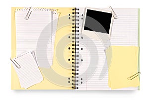 Photo album or scrapbook with polaroid photo frame and various pieces of notepaper, copy space