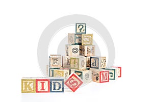 photo of a alphabet blocks spelling kids isolate on white background