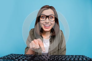 Photo of amazed computer nerd lady watch webcamera touch button keyboard isolated over blue color background