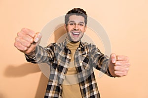 Photo of amazed crazy guy hold hands imagine drive fast speed race auto isolated pastel color background