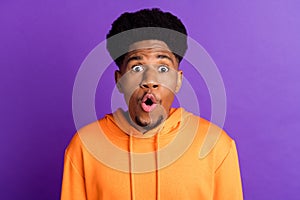 Photo of amazed shocked dark skin young man reaction face news wow isolated on purple color background