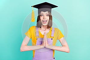 Photo of amazed shocked happy woman anticipate wear hat graduation isolated on pastel teal color background