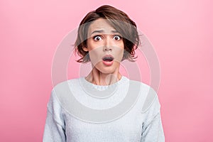 Photo of amazed shocked young woman afraid scared problem bad mood astonished isolated on pink color background