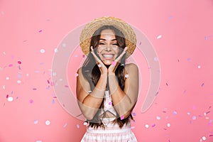 Photo of amazed woman 20s wearing straw hat laughing while stand
