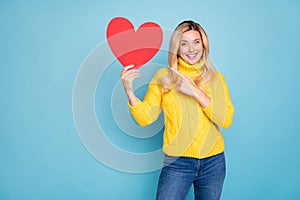 Photo of amazing blond lady holding big red paper heart date invitation indicating finger excited wear knitted yellow