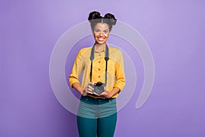 Photo of amazing dark skin lady holding photo digicam in hands positive cheerful mood photographer wear yellow shirt