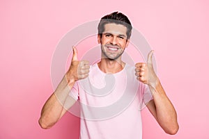 Photo of amazing guy approving tested product by raising thumbs up casual outfit isolated on pink background