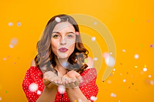 Photo of amazing lady blowing shiny confetti making fairy tale wear red dress isolated yellow background