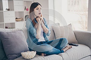 Photo of amazing lady watching long waited final episode of melodrama crying of lovers end sitting comfy sofa wearing