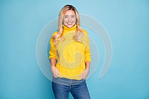 Photo of amazing pretty blond lady toothy smiling good mood holding hands in pockets wear warm knitted yellow jumper