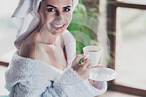 Photo of amazing young lady dressed head turban fluffy bathrobe enjoy coffee after spa salon procedure saturday morning